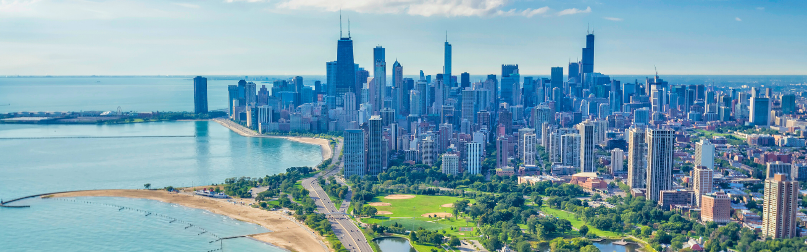 Aerial view of Chicago skyline and Lake Michigan shoreline, highlighting urban neighborhoods, beaches, and green space—ideal for real estate agents exploring Chicago market opportunities.