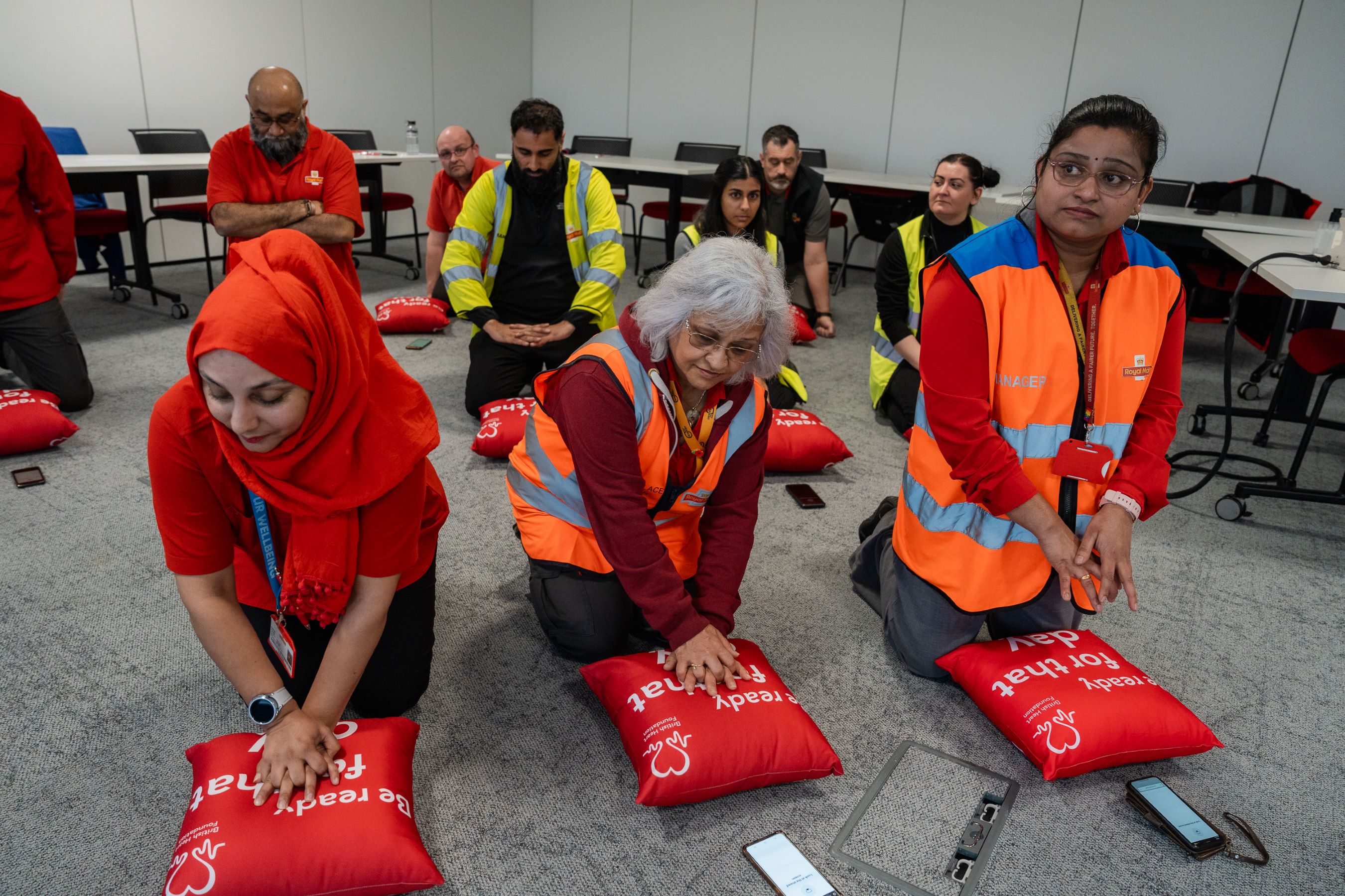employees practising CPR on pillows