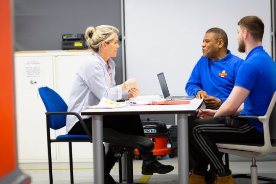 three engineers having a meeting