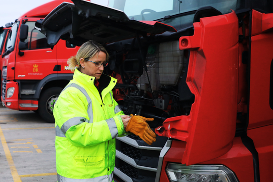 LGV driver next to lorry putting on gloves
