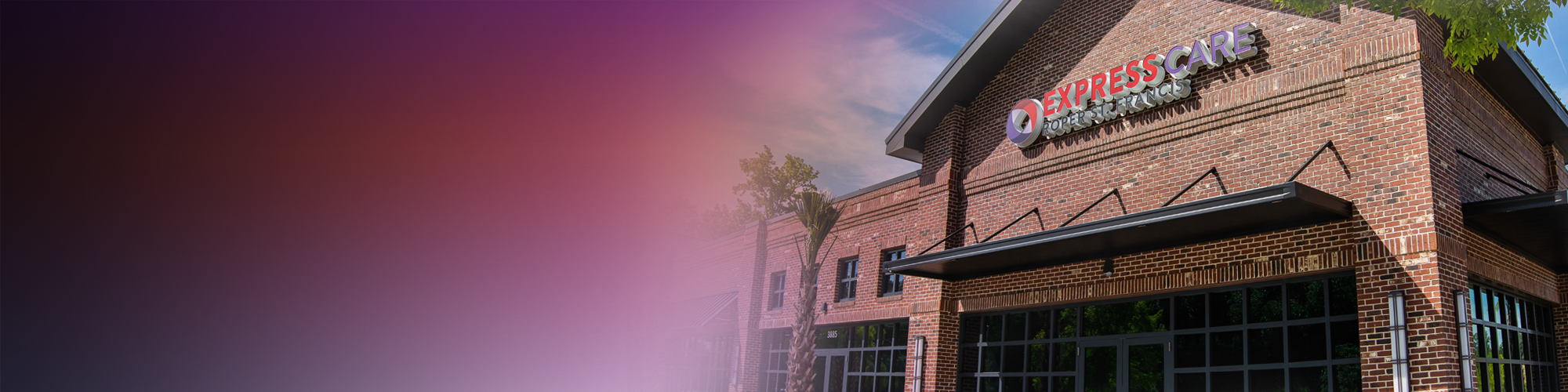 Exterior of a brick Express Care clinic by Roper St. Francis, featuring large windows and a modern facade under a clear sky.