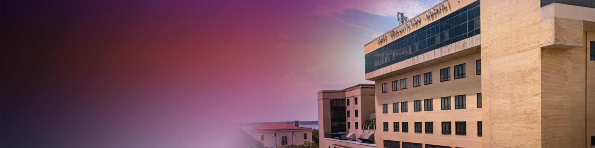 Exterior of a tan building and sky with a blurred gradient background transitioning from dark to light tones