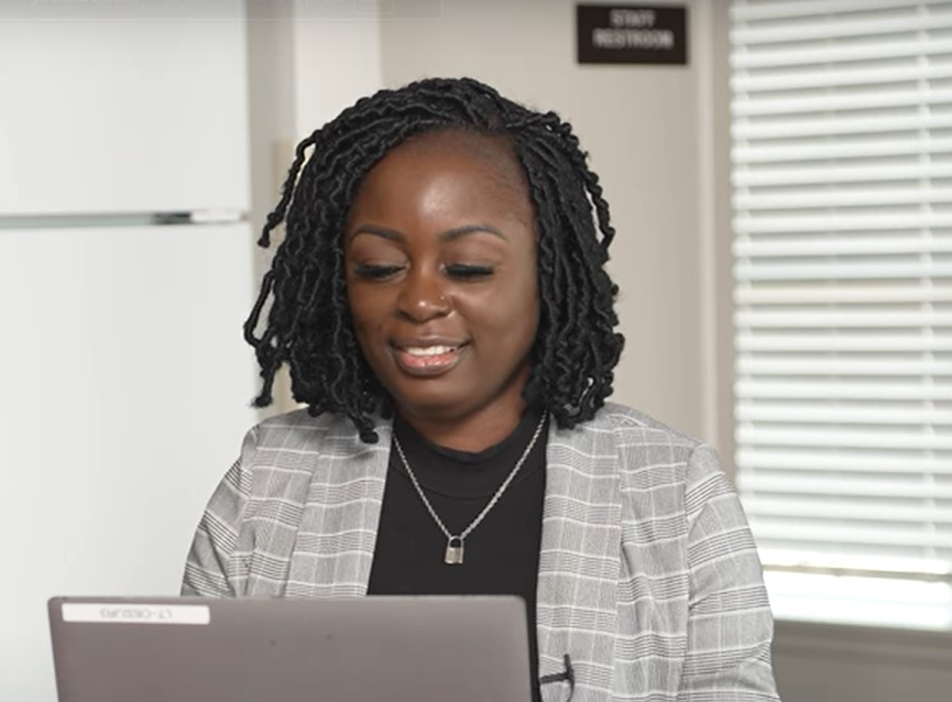 Woman smiling while working on a computer