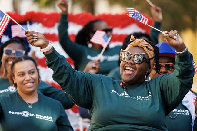 smiling teammates at veterans day parade