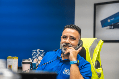 male employee talking on a phone in an office