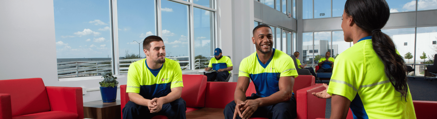 three employees sitting down and talking