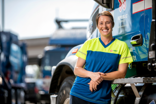 woman-leaning-against-truck-employee-smiling