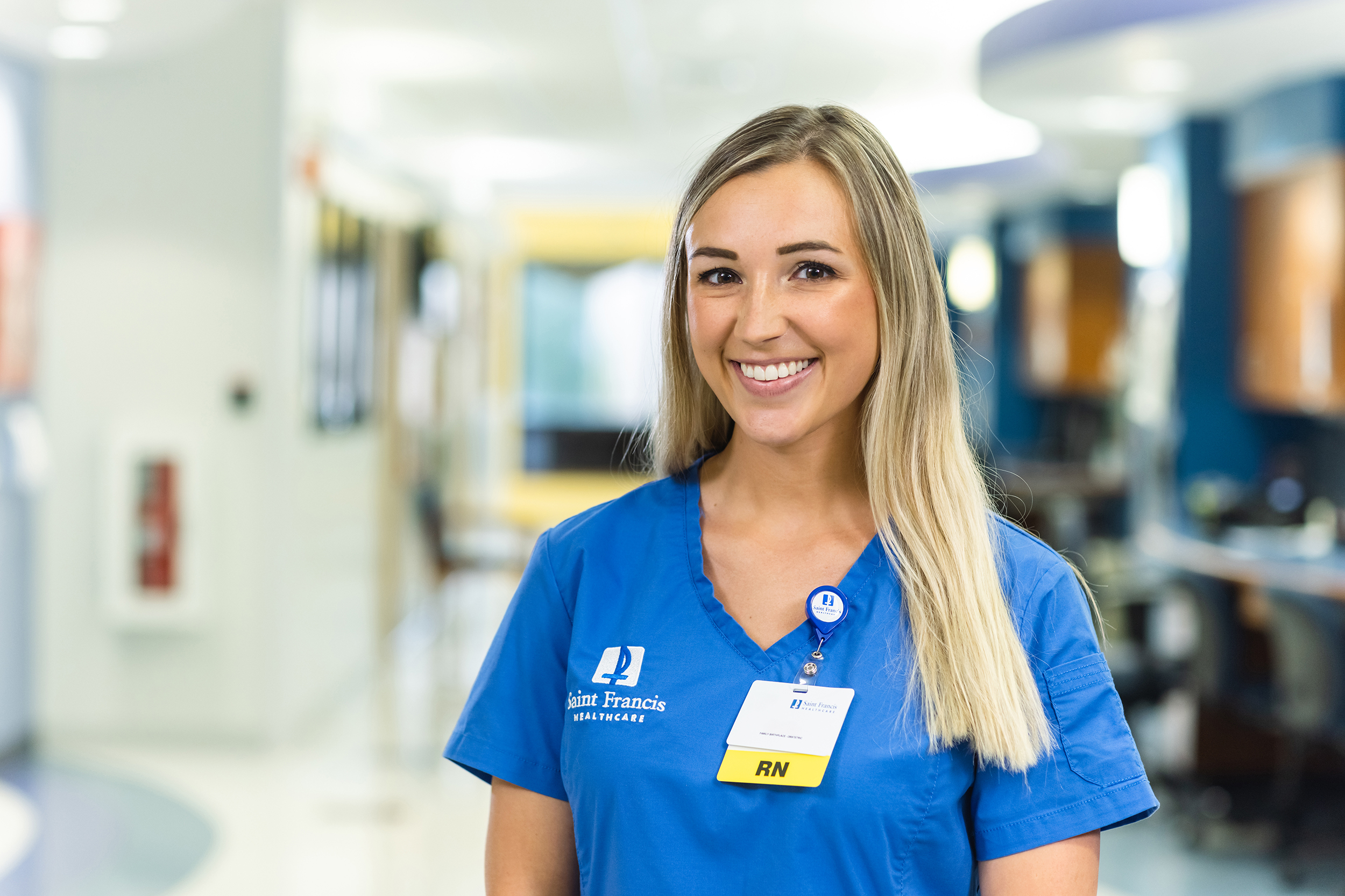 A Saint Francis nurse stands in a hospital hallway