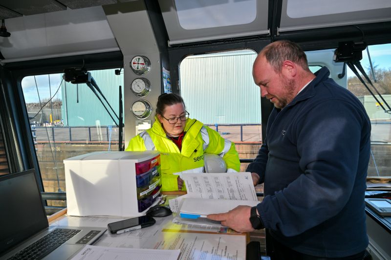 Carrie Harris and Senior Boatmaster John Robertson in the wheelhouse of SD Mars while in dry dock for maintenance at our Great Harbour maritime site in Scotland.