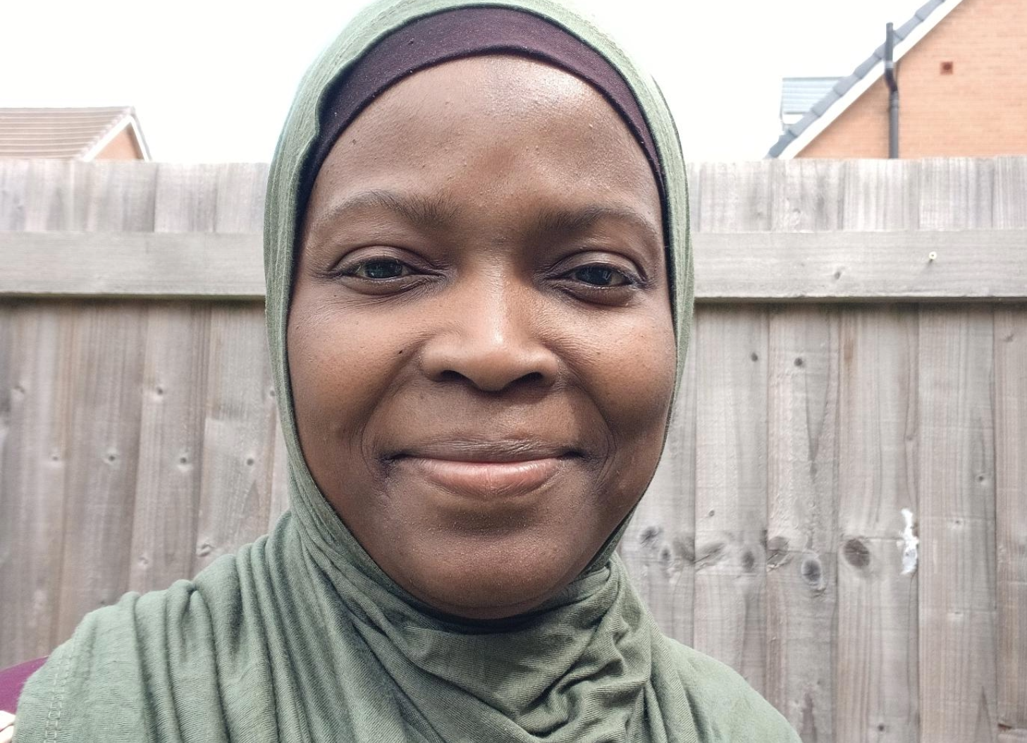 A woman in a green head scarf