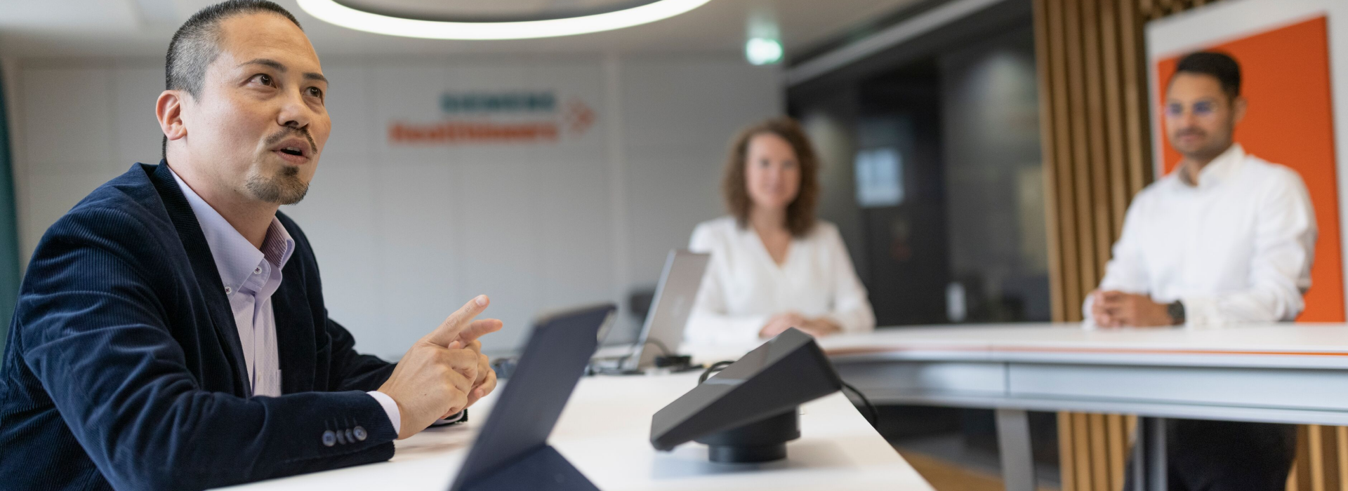 A diverse cybersecurity team in an office meeting sharing a desk