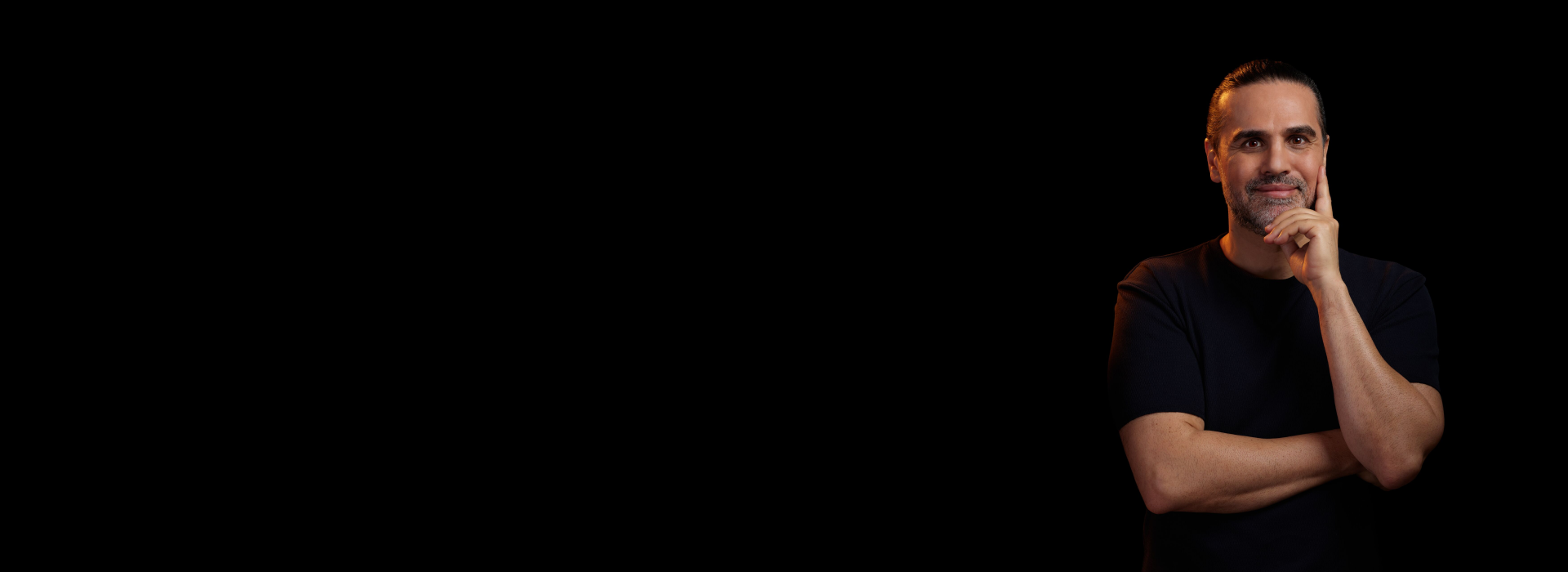 Man with arms folded smiling