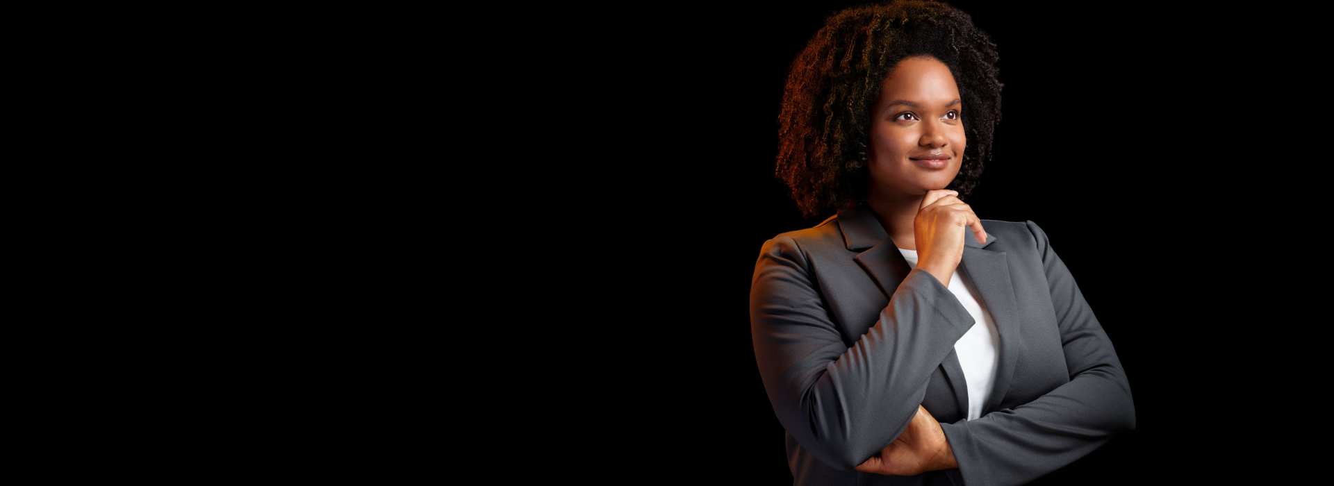 Women smiling with folded arms and touching her chin