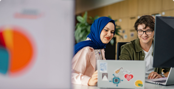 Healthineers sitting in front of a laptop at a desk