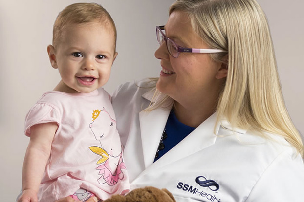 smiling doctor with young patient