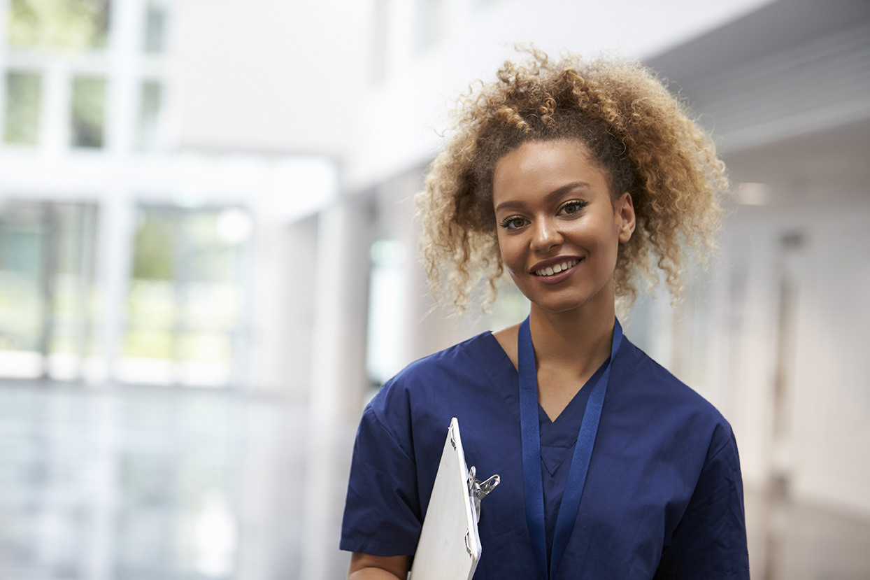 Smiling SSM Health employee in blue scrubs
