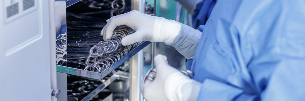 Sterile processing technician sanitizing instruments