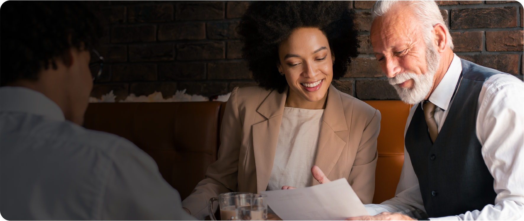 Male and female coworkers look at a piece of paper together