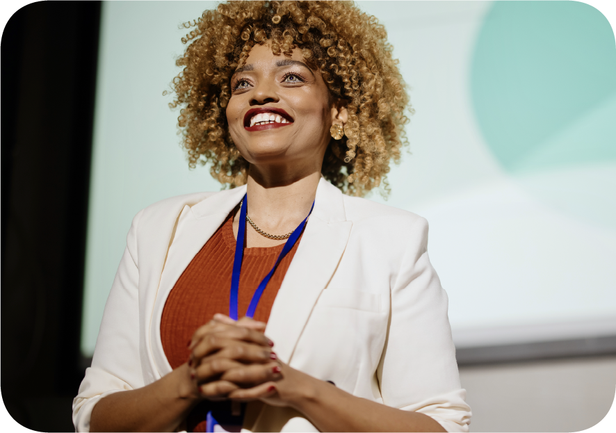 Smiling woman standing in front of a display screen