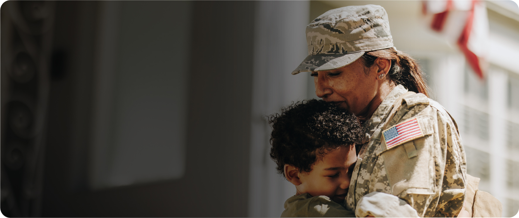 Female soldier hugging a young boy
