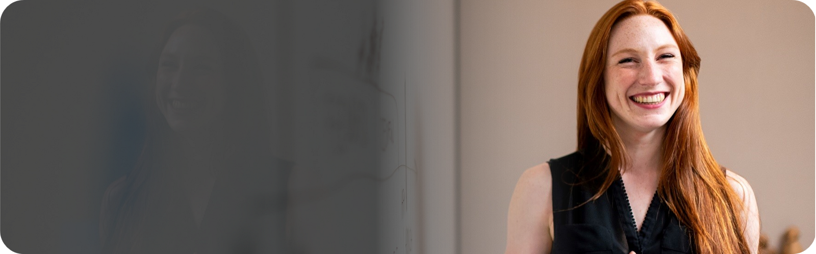 Smiling woman in front of whiteboard