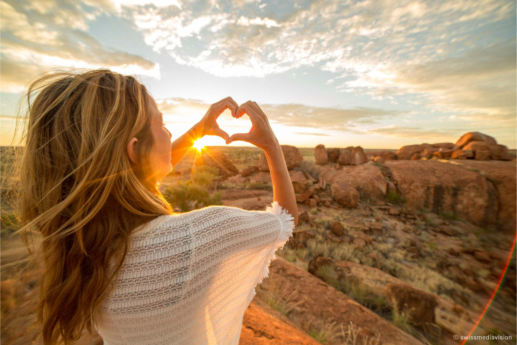 A person making a heart with her hands