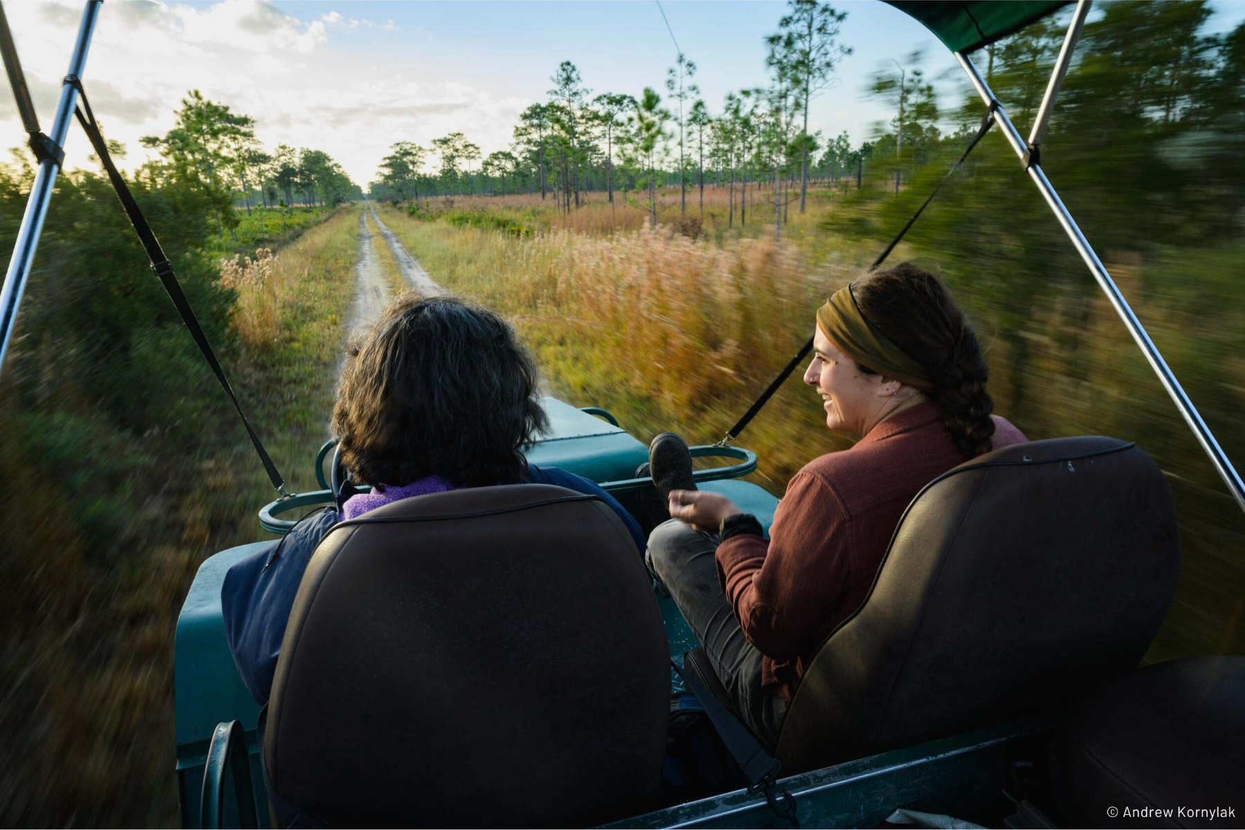 A couple of people riding in a vehicle
