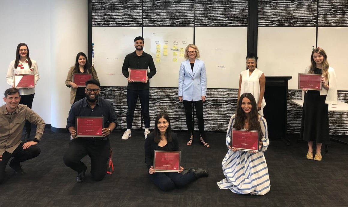 TJX Colleagues holding up TJX Certificates and posing for the picture