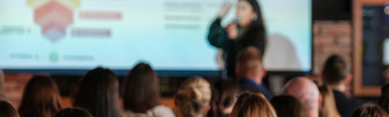 A speaker is giving a presentation to team members. 