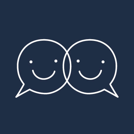 Two connected speech bubbles with smiley faces. 