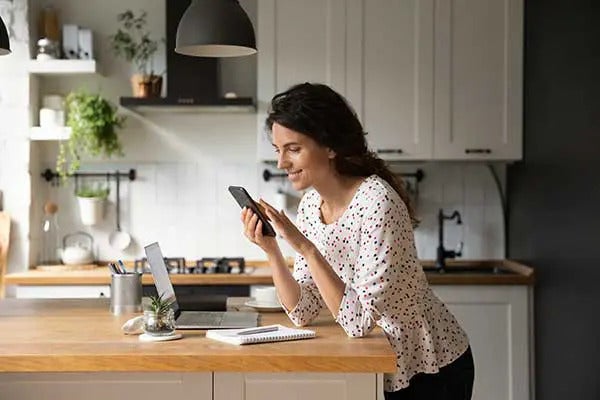 1766007108431_woman-using-phone-in-kitchen