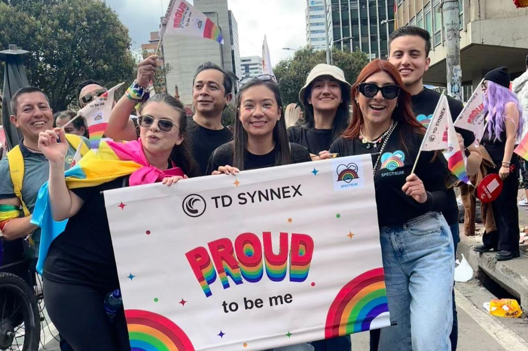 Spectrum BRG members holding a "Proud to Be Me" banner at a pride parade