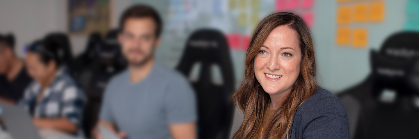 Woman sitting at table with coworkers.