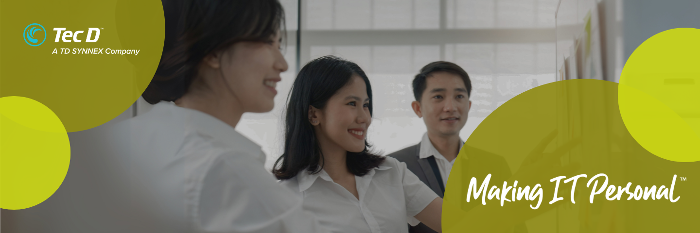 Coworkers standing together pointing to a poster with a border of yellow circles