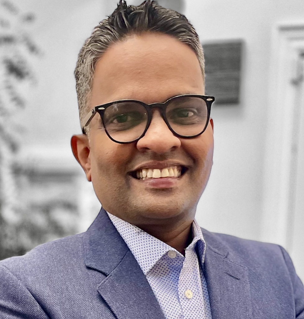 Headshot of a man in business clothes with glasses