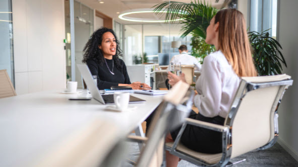Two women sitting across desk during interview