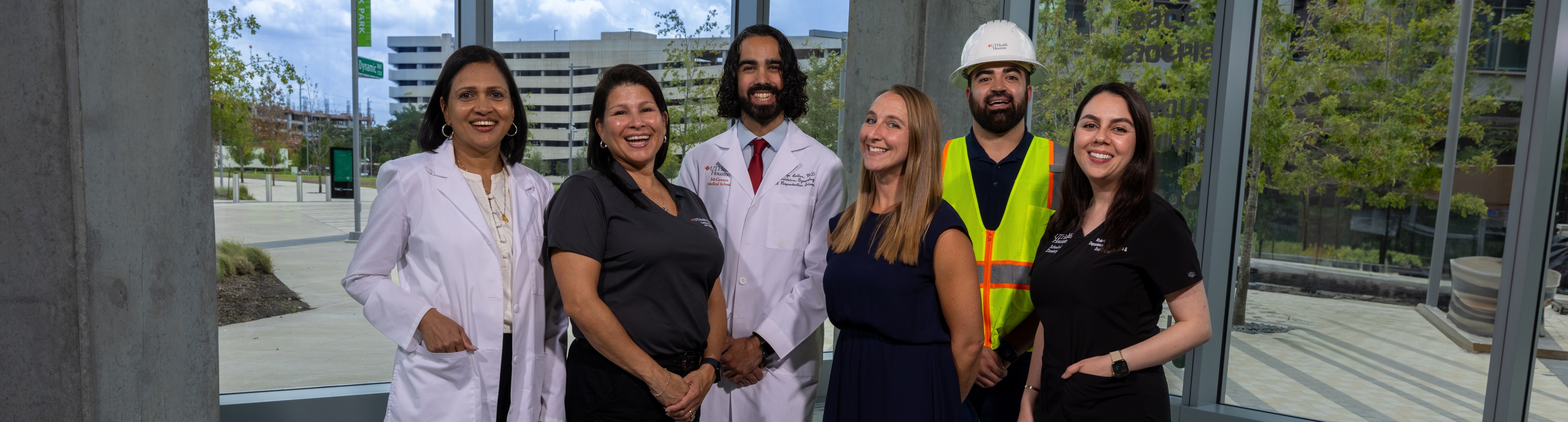 A group of UTHealth Houston employees from various positions standing together.