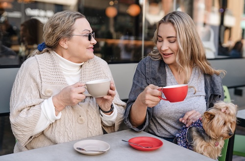 Mother, daughter and dog at restaurant