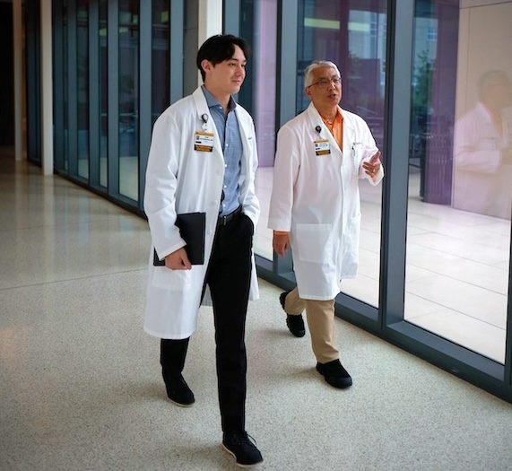 Two doctors walking down a hallway