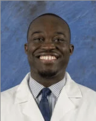 Doctor in white coat with blue background.