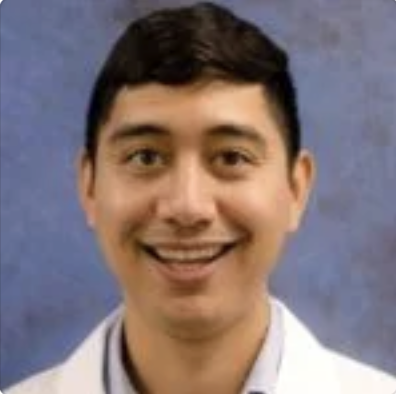 Doctor in white coat with blue background..