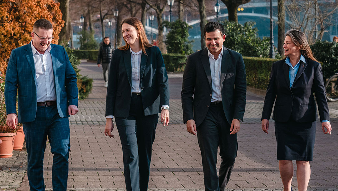 Office-Staff-Group-Walking-Promenade-Basel-1083x612-2
