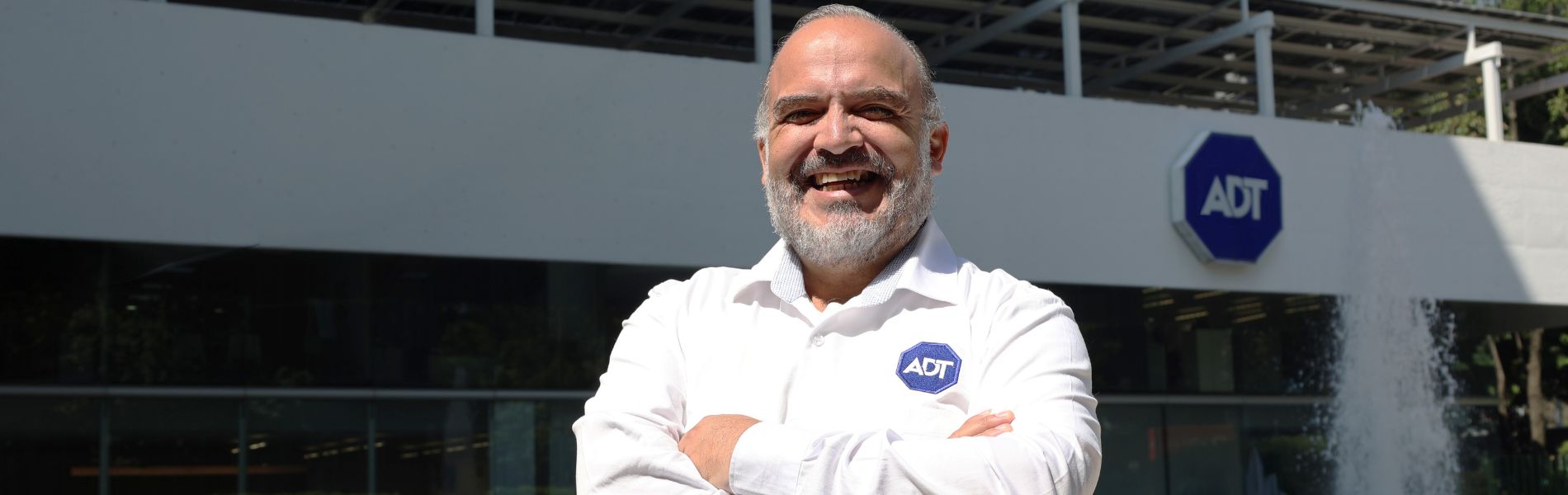 Comercial de ADT posando con brazos cruzados.