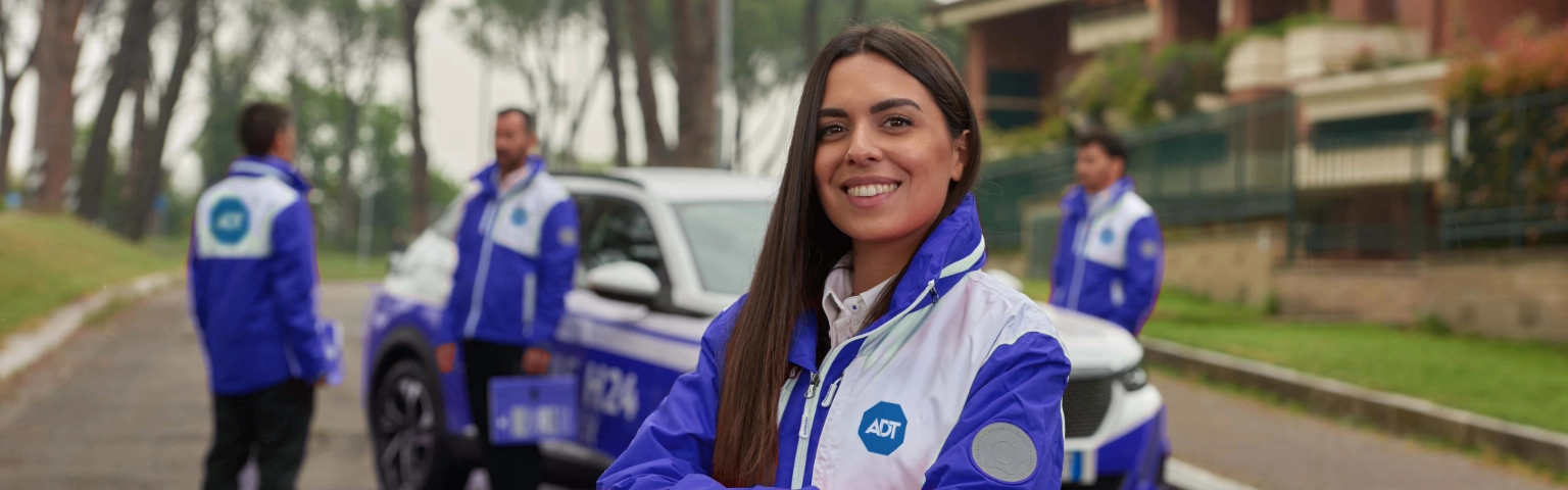 Comercial de ADT México con coche y chicos de fondo.