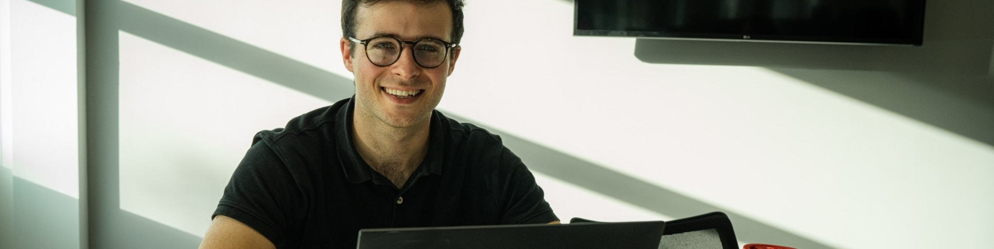 Intern at Verisure office with open laptop