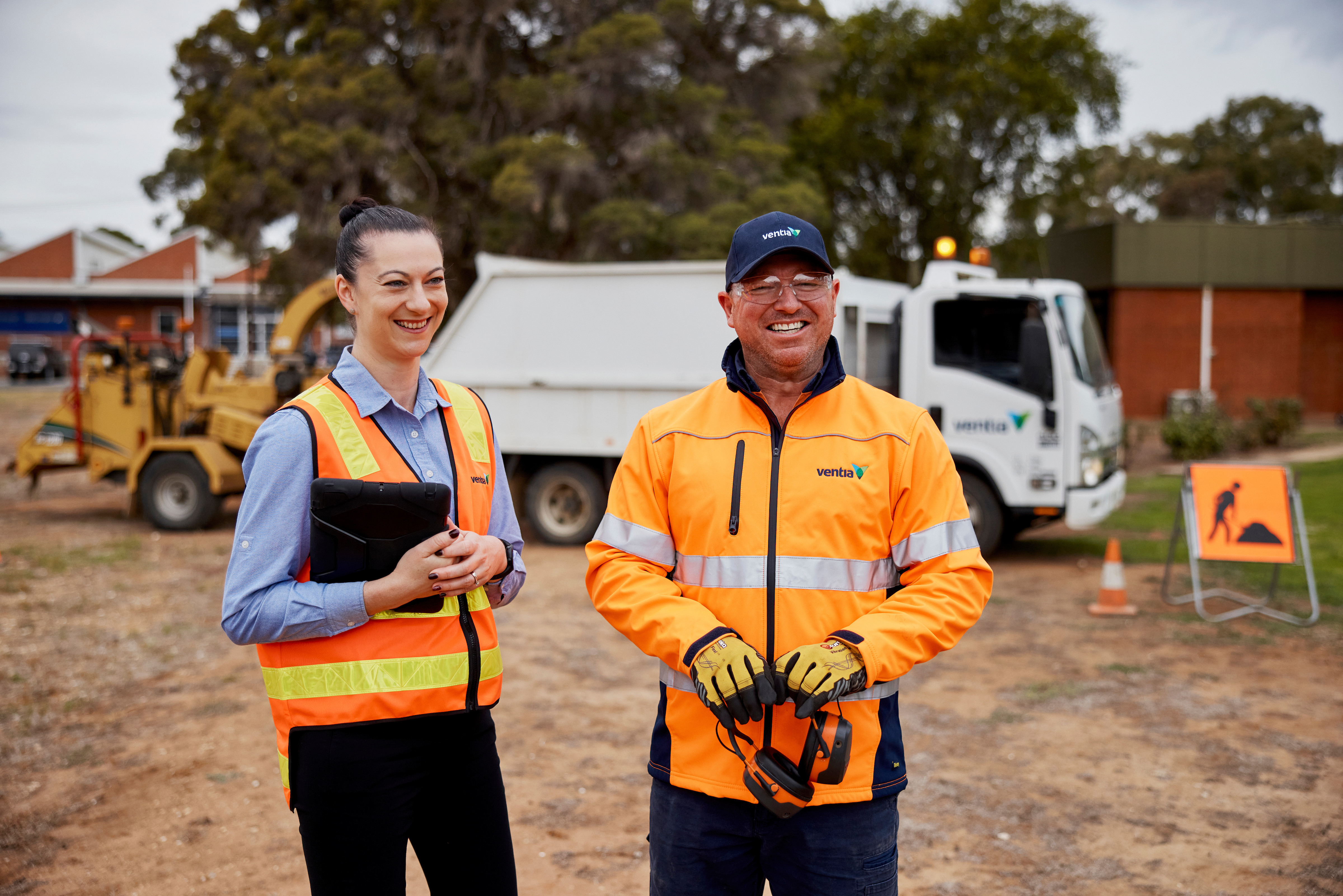 Two people in orange hi vis smiling