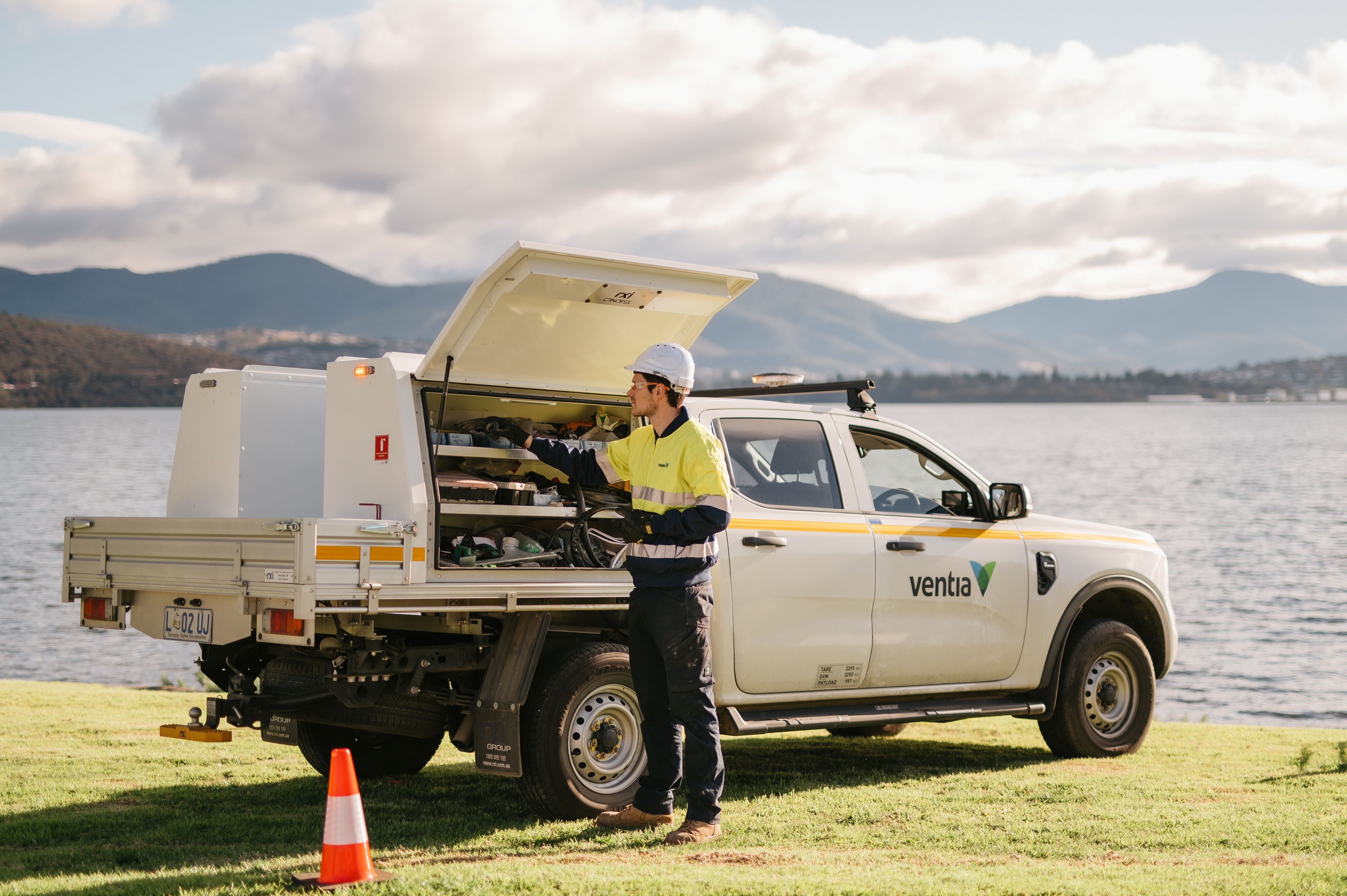 Man standing in front of white ute