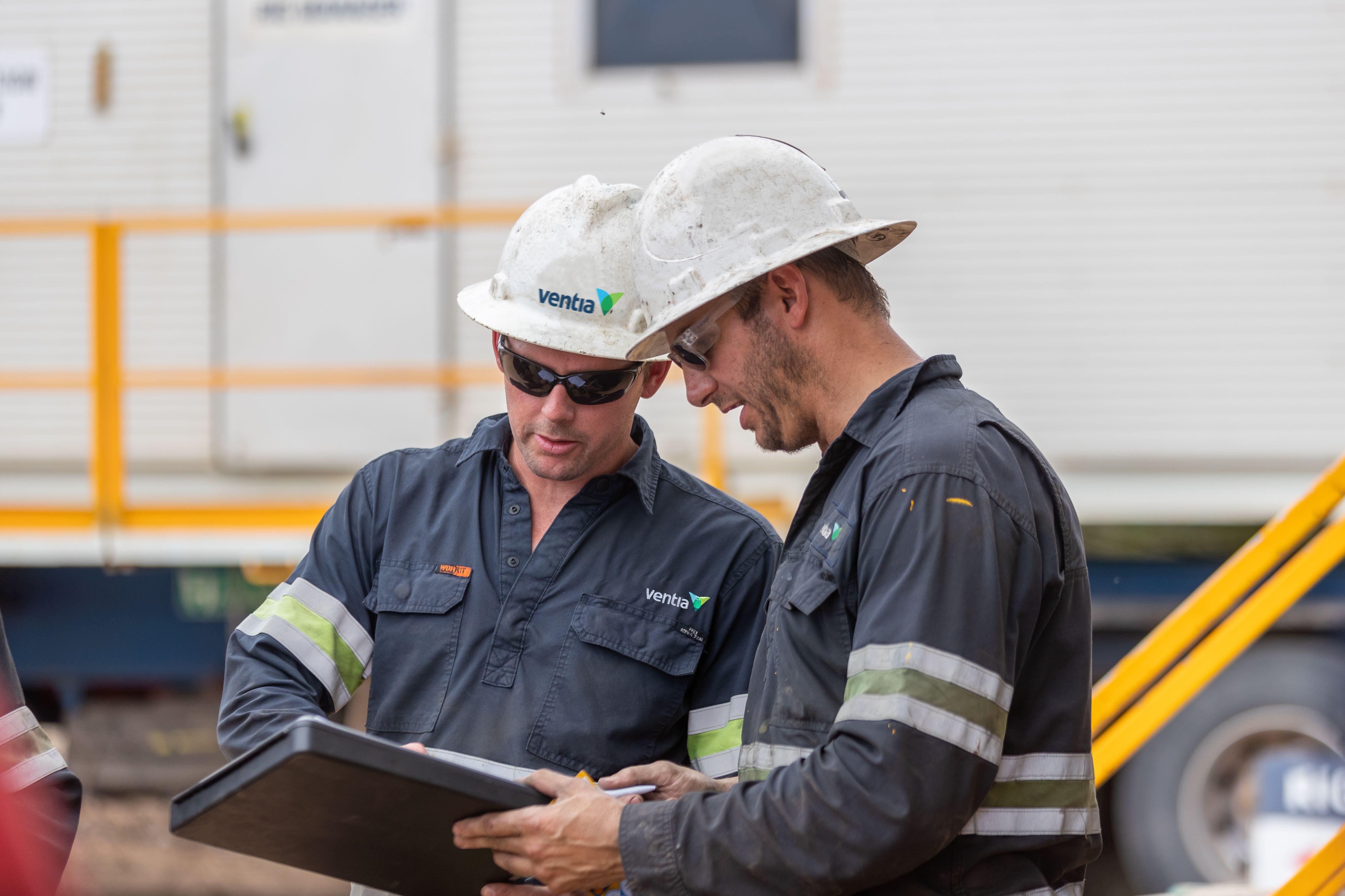 rig workers reviewing documentation
