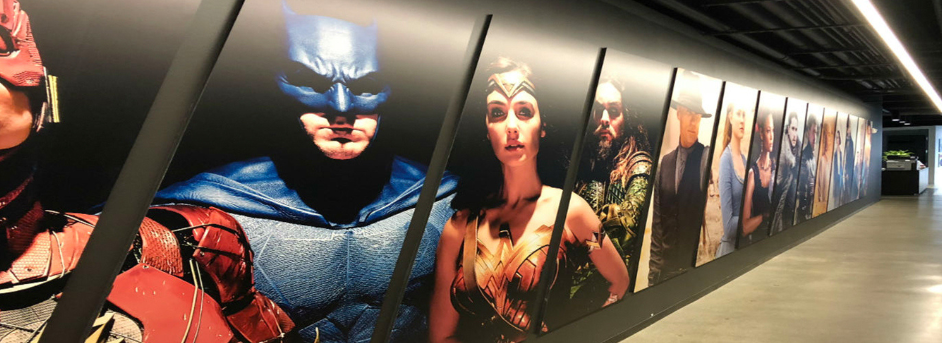 Office Corridor with a collage of iconic characters including Batman and Wonder Woman