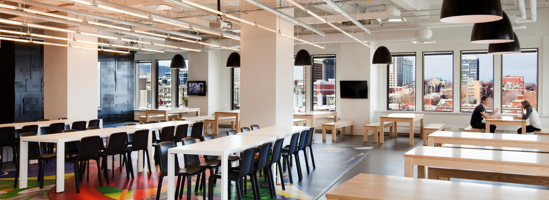  Two employees meeting in the cafeteria at the Warner Bros. Games Montreal office